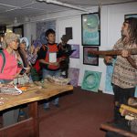Gilbert Laurie explaining regional patterns on didgeridoos at Nimbin's Aboriginal Cultural Centre